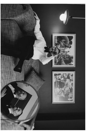 A creative and artistic groom portrait. The reflection in the mirror and the unusual angle make this black and white shot a unique and memorable piece of art.