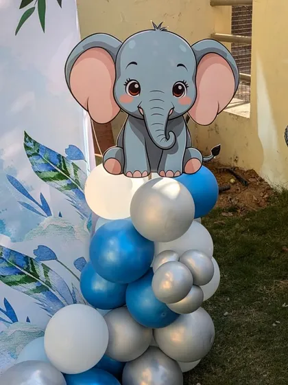 I love adding small details like this cute elephant cutout on top of a balloon pillar. It really helps bring the theme to life.