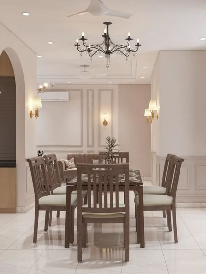 A classic dining room setup with a traditional wooden table and chairs. The space is defined by elegant wall molding, arched doorways, and classic chandeliers, creating a timeless and formal feel.