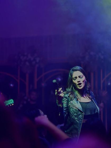 Lost in the music under the purple and green stage lights. A candid moment of me singing my heart out.