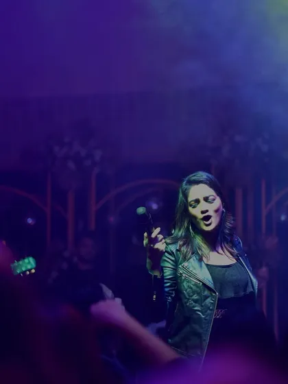 Lost in the music under the purple and green stage lights. A candid moment of me singing my heart out.