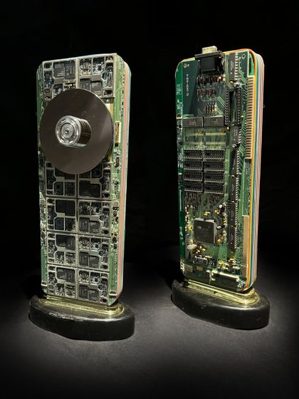 A pair of custom awards made from repurposed hard drive components and circuit boards. These pieces showcase how I can create a series of related but unique trophies for different award categories.