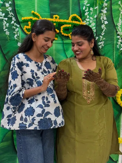 A sweet moment captured between me and my friend as she admires her bridal mehendi. It's always an honor to be a part of such special moments.