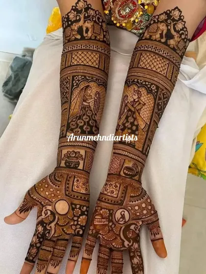 A classic varmala ceremony illustrated in this full coverage bridal mehndi. The design captures the moment the bride and groom exchange garlands, surrounded by peacocks and auspicious symbols.