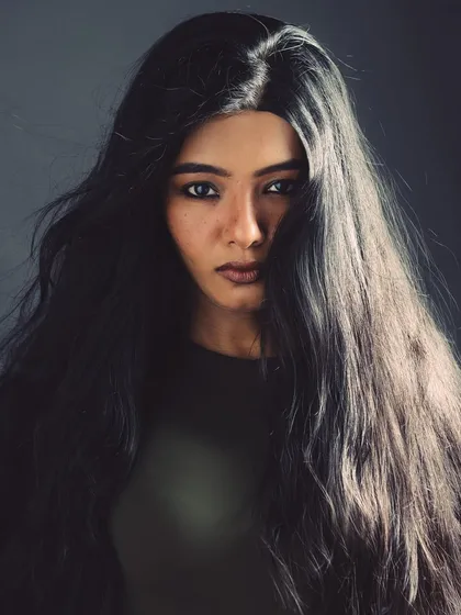 This portrait is all about the hair. The lighting is set up to emphasize the volume and texture, creating a wild and free look.
