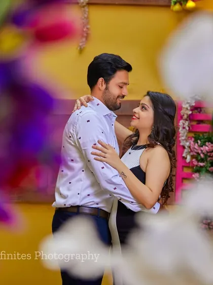 A close-up portrait framed by flowers, creating a soft and romantic feel that draws all the attention to the couple's happy expressions.