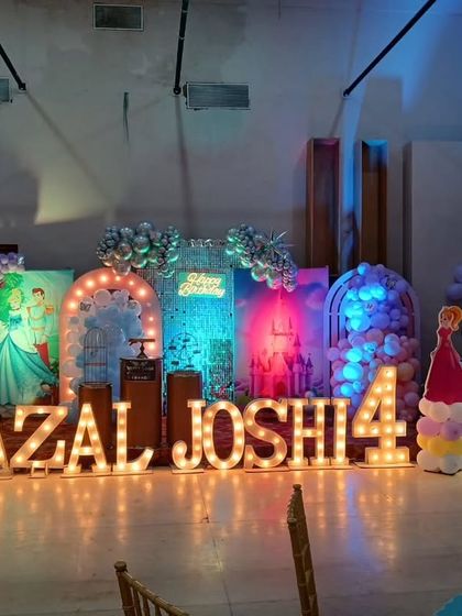 The full stage setup with chairs in the foreground, giving a sense of the event space and layout.