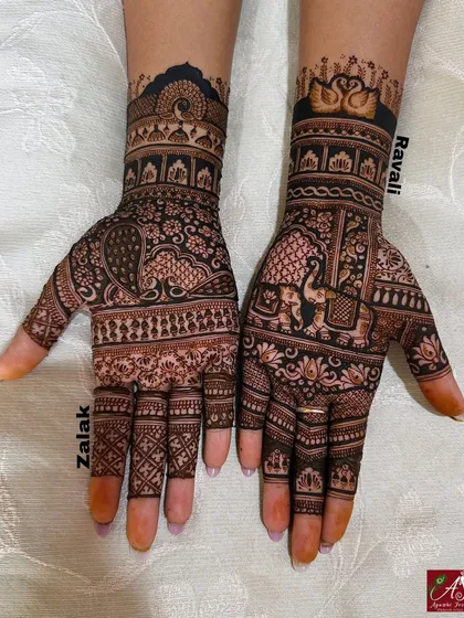 A heavy Indian mehendi design that I got done on my own hands. It features beautiful peacocks, elephants, and swans, showing the kind of intricate work I love.