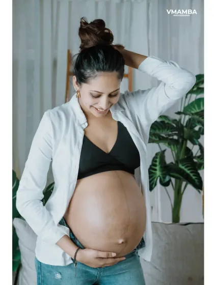 A candid moment during a boho maternity session. I encourage moms-to-be to interact naturally with their bump, resulting in authentic and emotional portraits.