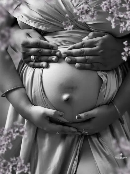 Sometimes, the most powerful stories are told in black and white. This artistic close-up focuses on the hands of the expecting parents cradling the baby bump, a simple and profound symbol of their growing love.
