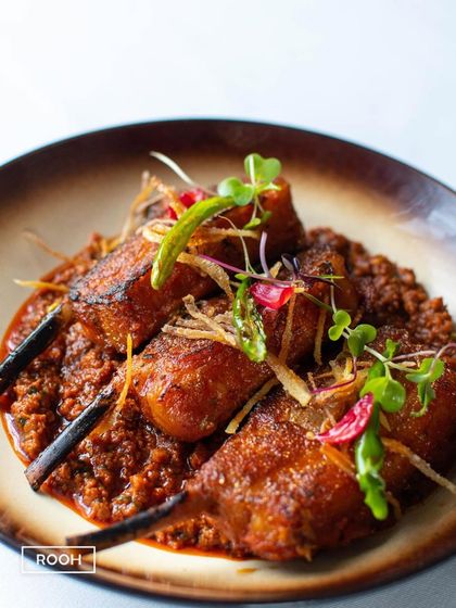 The Lamb Chop Raara, plated with fresh ginger and green chili. This dish is a perfect example of robust North Indian flavours presented with modern elegance.