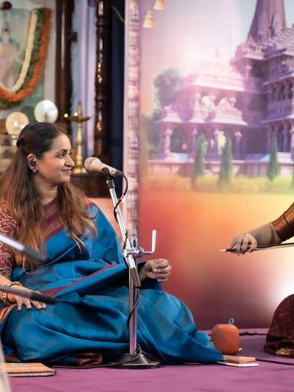 Sharing a smile with the violinist on stage at the Ramotsava concert. The joy of making music together is evident in these small, happy interactions.