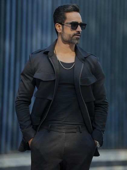 Another view of the black GT tracksuit, showcasing its sleek design and tailored fit.