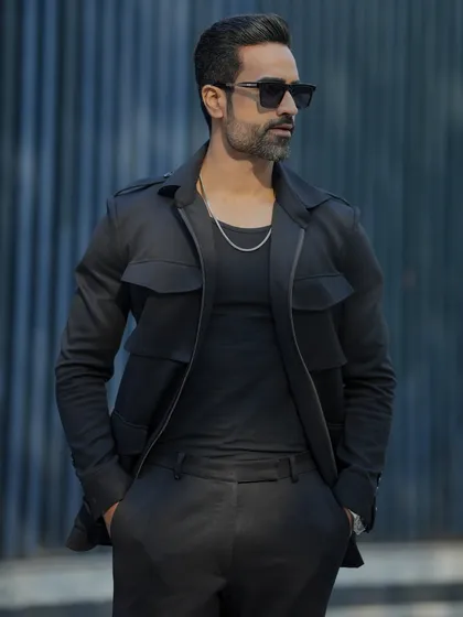 Another view of the black GT tracksuit, showcasing its sleek design and tailored fit.