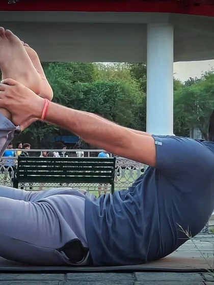 This is Dhanurasana, or Bow Pose, a powerful backbend for improving spinal elasticity. I guide my clients through this pose carefully, as it can be very beneficial for strengthening the back and managing issues like a slipped disc when done correctly.