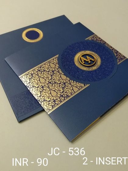 A bold and modern invitation in royal blue with a gold patterned band and a custom monogram. This design is perfect for a glamorous evening reception.
