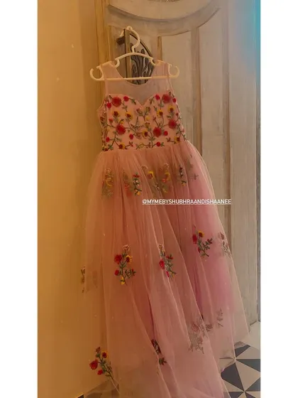 From our studio to your celebration, this pink tulle gown is a fairytale brought to life. The bodice and skirt are adorned with hand-placed floral embroidery, making it a perfect custom dress for a young fashionista.