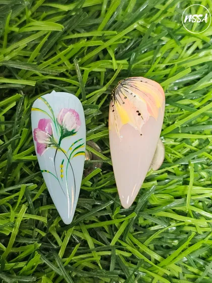 Beautiful floral nail art painted by our students. They learn to create depth and dimension using simple brush strokes and color blending techniques.