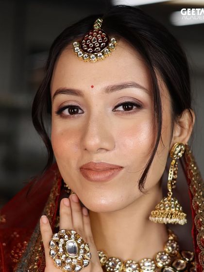 A close-up of a student's bridal creation, focusing on a natural, dewy base and soft brown eye makeup. We teach the art of enhancing features while maintaining a timeless elegance.