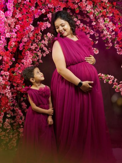 A full-length view of the matching mother-daughter maternity gowns. It’s a wonderful way to celebrate the growing family and create photos you will cherish forever.