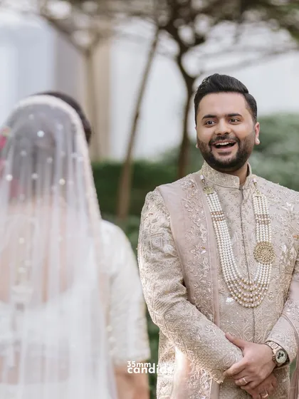 She walked in, and time slowed. He looked up, and in that tiny moment, they both just knew. This is the groom's first look, a priceless, candid reaction of pure joy and adoration.