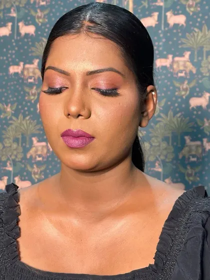 A close up with eyes closed, showcasing the shimmery pink eyeshadow and flawless eyeliner. This look proves that bold colors look incredible on every skin tone.