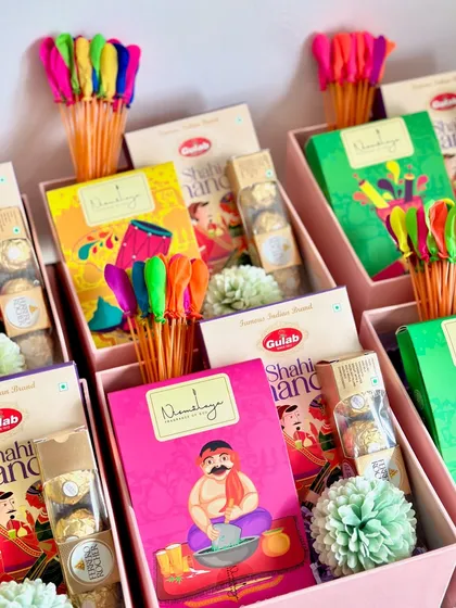 An inside look at our colorful Holi return favor boxes. The bright packaging of the Shahi Thandai and the vibrant water balloon sticks instantly create a festive mood, promising a day full of fun and laughter.
