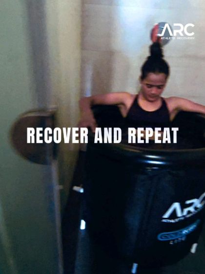Recover and repeat. A female athlete uses an ice bath for recovery after an intense training session. This emphasizes our holistic approach to performance, where recovery is as crucial as the workout itself.