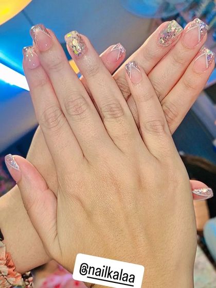 A pretty and delicate design with a sheer base, silver glitter, and fine white line art.