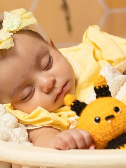 A sweet newborn sleeping in a basket as part of our sunflower and bee theme, showing how I can incorporate themes even for the tiniest clients.