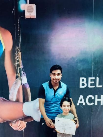 A proud moment as this student receives his certificate in front of our motivational wall.