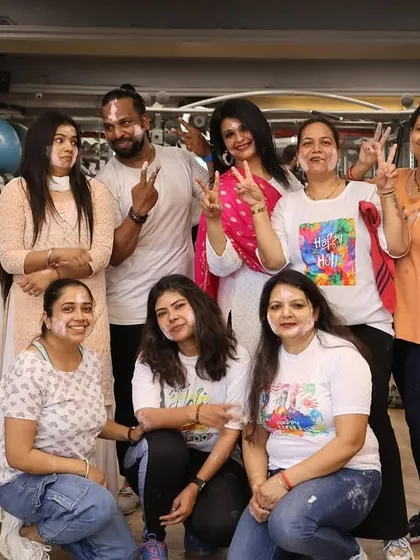 Victory signs and smiles all around during our fun-filled Holi party.