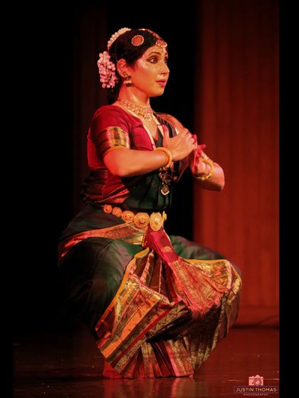 This image captures the 'araimandi' or half-seated posture, which is fundamental to Bharatanatyam. It requires immense strength and stability.