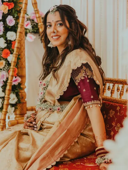 The mom-to-be seated on the traditional swing for her baby shower ceremony, looking serene and beautiful.
