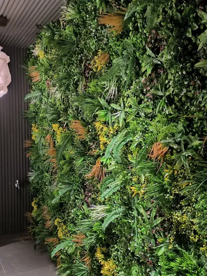 This premium quality artificial green wall was a recent project in Vasant Vihar. The mix of different leaf types, colors, and textures creates a highly realistic and luxurious look for this commercial interior.