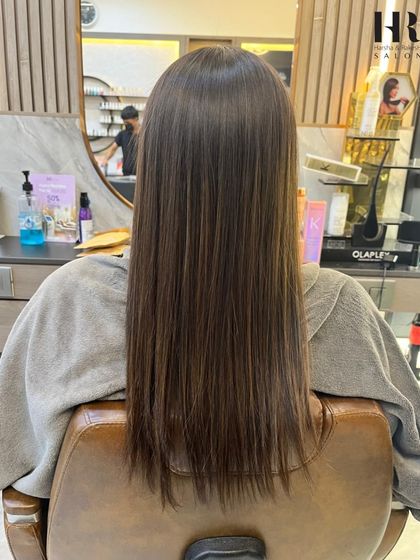 The stunning "after" result of a smoothing treatment. The hair is now sleek, healthy, and has a beautiful, subtle color dimension.