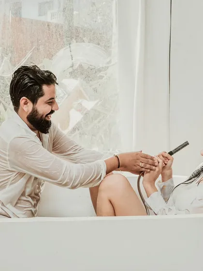 Laughter fills a bathtub in this playful and intimate indoor pre-wedding shot from a Goa session. We love capturing these unscripted, real moments that show a couple's true connection.