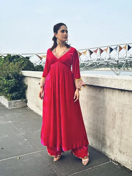 A pop of pink for Nushrratt Bharuccha in Ahmedabad. This velvet maxi dress with embellished cuffs is a comfortable yet glamorous choice for travel and promotional events.