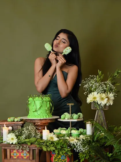 A cute and playful pose with cakesicles from the birthday dessert table.