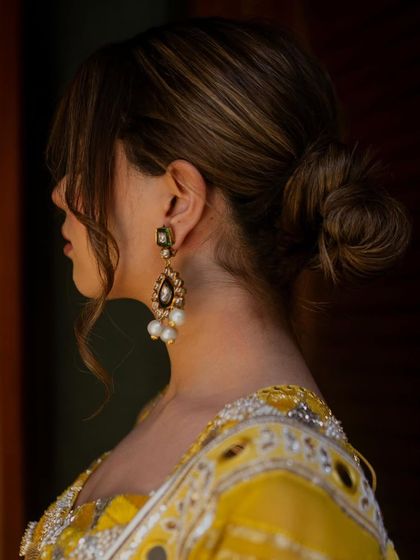 A detailed shot of the messy bun, which adds a touch of modern effortlessness to this traditional look.