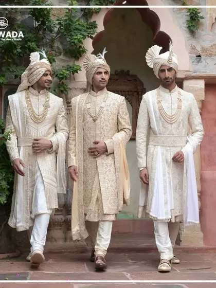 A group of three grooms walking, showcasing the movement and grace of the Shauhar sherwanis. This image captures the camaraderie and shared elegance of a wedding party.