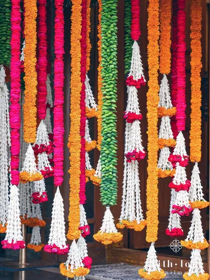 A close-up of the vibrant floral garlands used in a traditional Pellikuthuru ceremony.