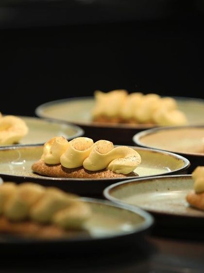 A dessert in progress: piped crémeux on a sable biscuit base, ready for its final garnishes.