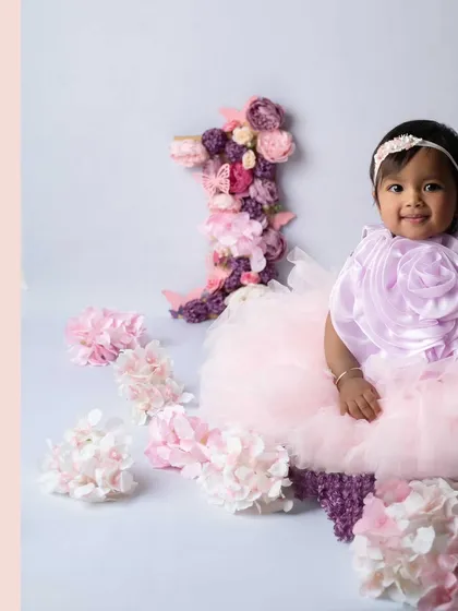 A full view of the beautiful floral setup for this first birthday photoshoot. The soft colors and delicate details create a perfect setting for a little princess.