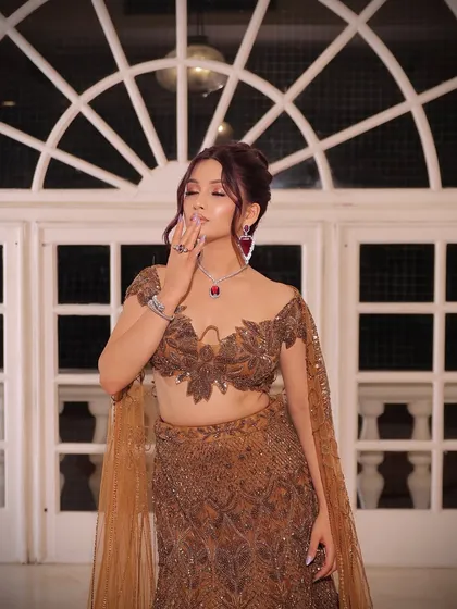 A close-up of the bride, showing her soft, smoky eye makeup and the intricate details of her blouse.