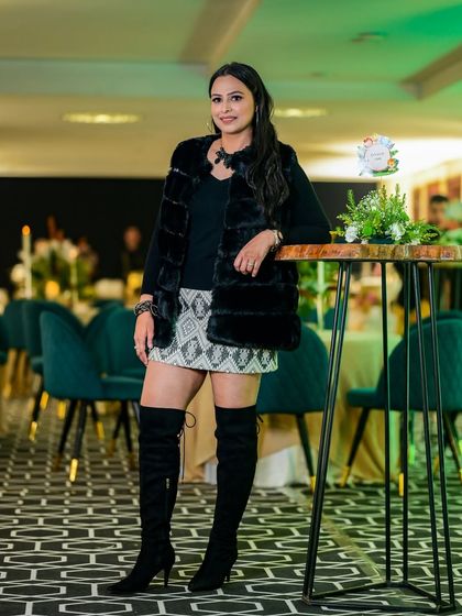 A guest enjoying the jungle themed party atmosphere. The decor, with its green and black color scheme and rustic elements, created a chic yet fun setting for all the guests, not just the kids.