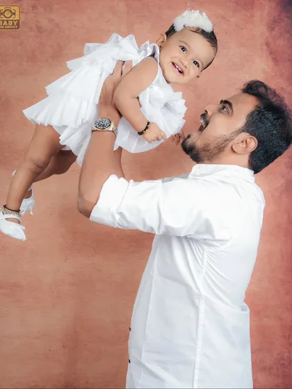 The special bond between a father and his daughter, captured in a moment of pure joy as he lifts her high.