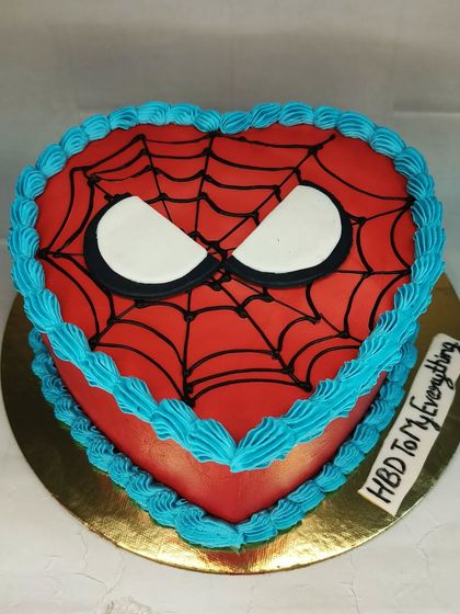 A unique heart-shaped Spiderman cake. This chocolate mousse cake combines a romantic shape with a superhero theme for a fun and unexpected design.