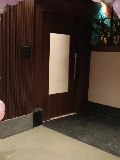 The entrance to the 10th birthday party, with a balloon arch in shades of pink, purple, and gold leading into the venue.