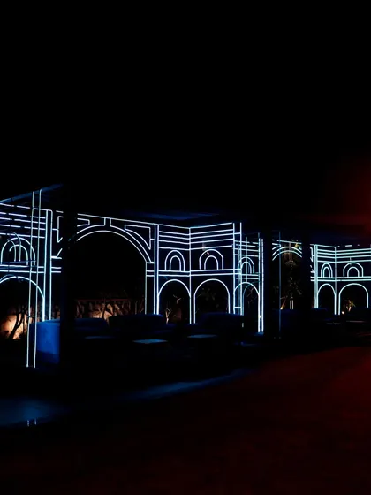 The exterior of the venue was outlined with white neon, transforming the building's architecture into a piece of live art and setting the tone from the moment guests arrived.